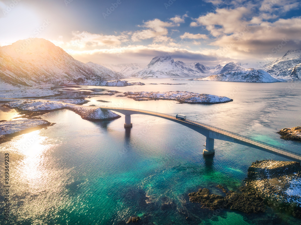 Aerial view of bridge over the sea and snowy mountains in Lofoten Islands, Norway. Fredvang bridges 