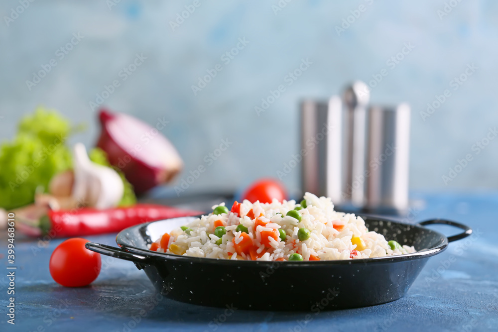 Plate with tasty pilaf on table