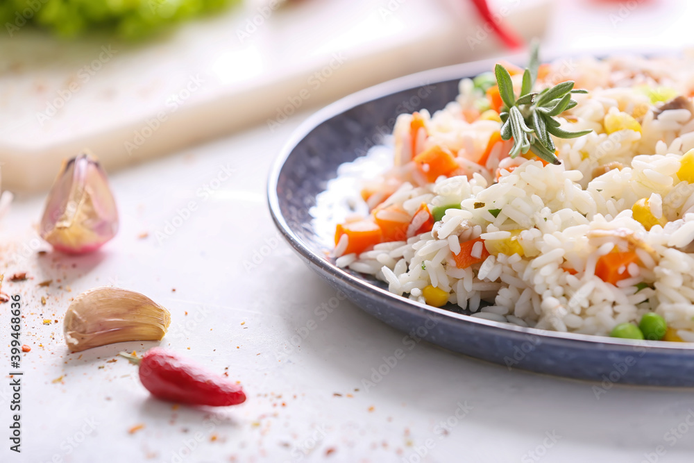 Plate with tasty pilaf on table