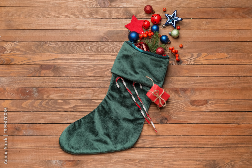 Composition with Christmas sock on wooden background