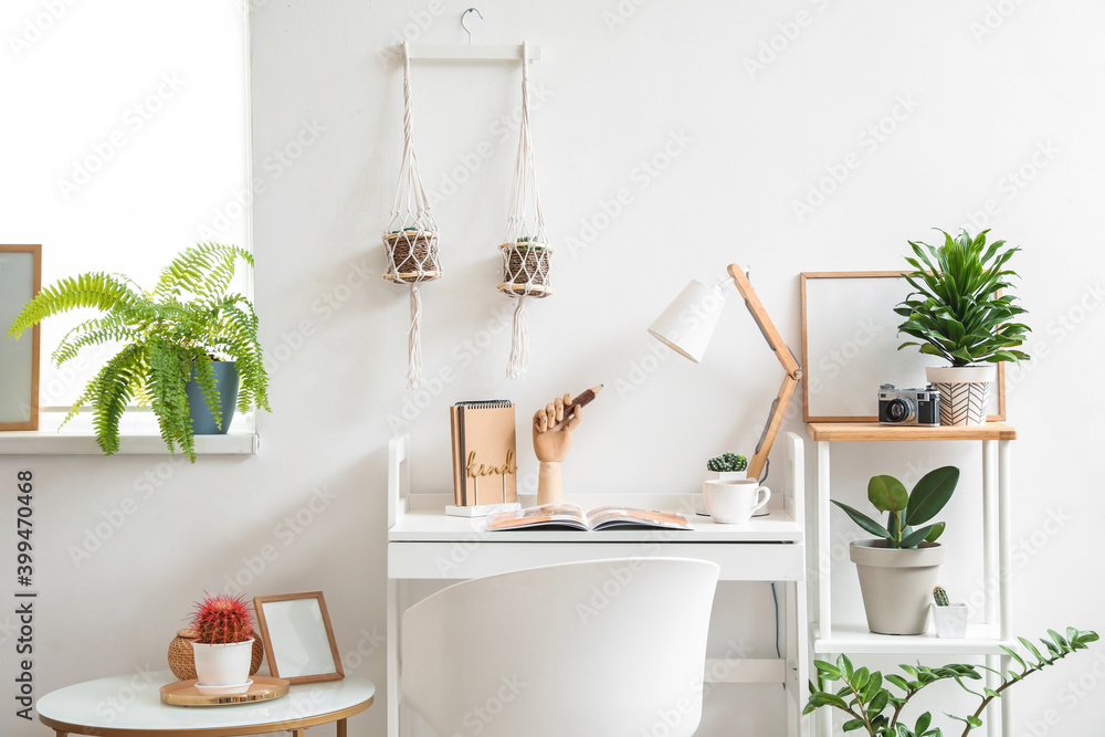 Wooden hand with lamp on table in interior of room