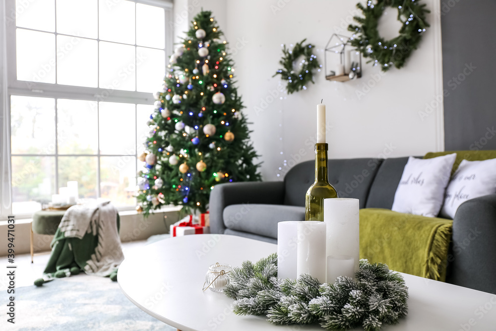 Candles in interior of living room decorated for Christmas