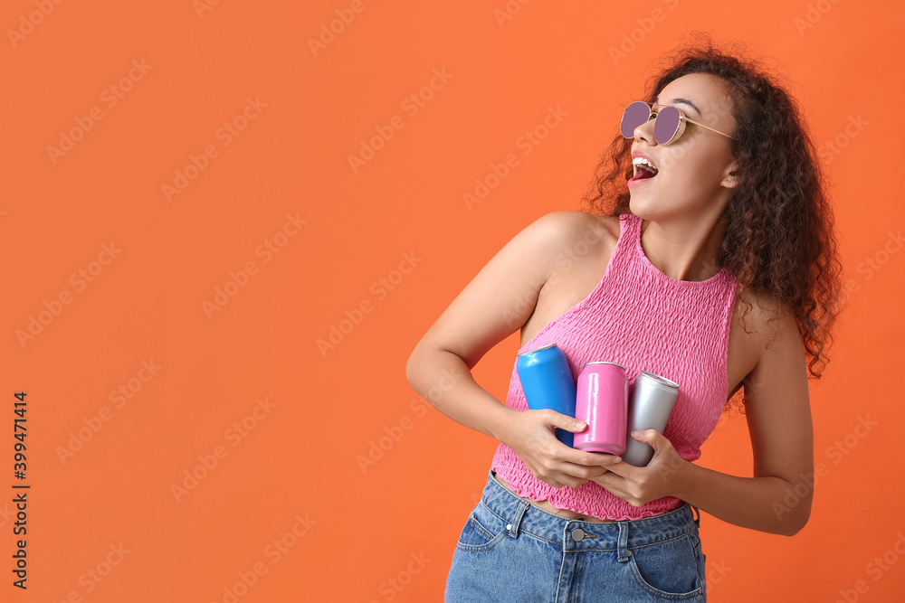 Beautiful African-American woman with soda on color background