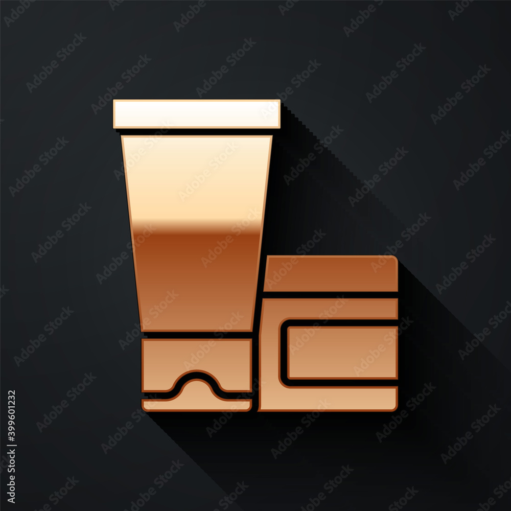 Gold Cream or lotion cosmetic tube icon isolated on black background. Body care products for woman. 