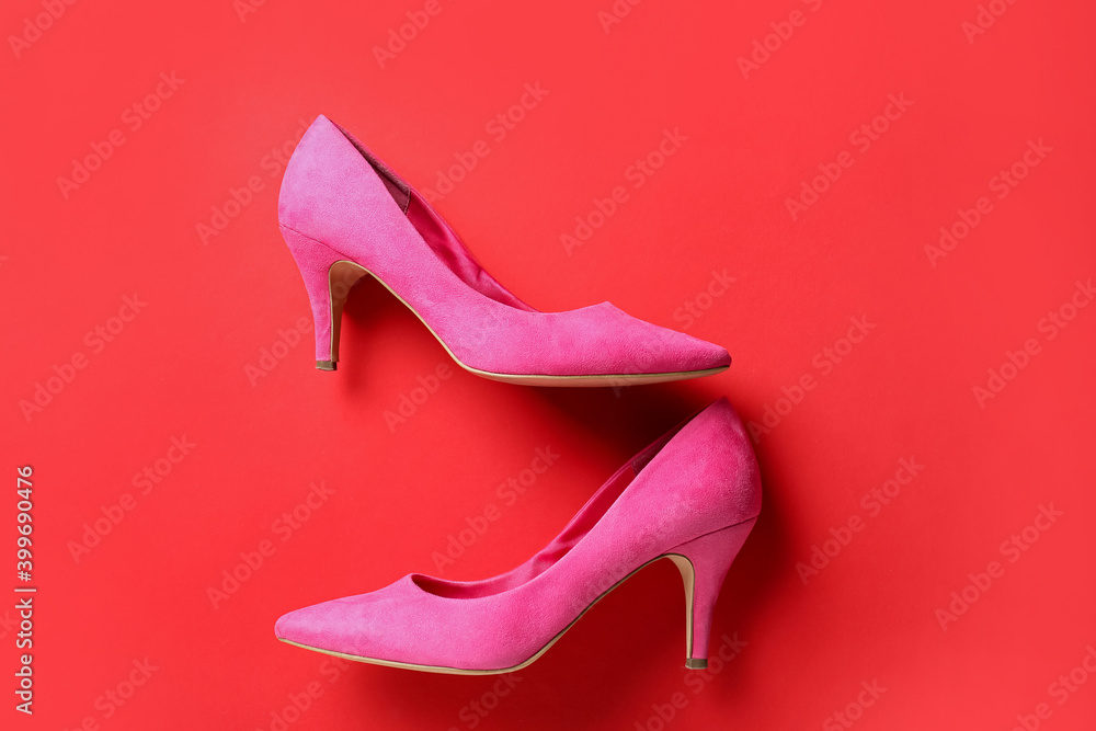 Female shoes on color background