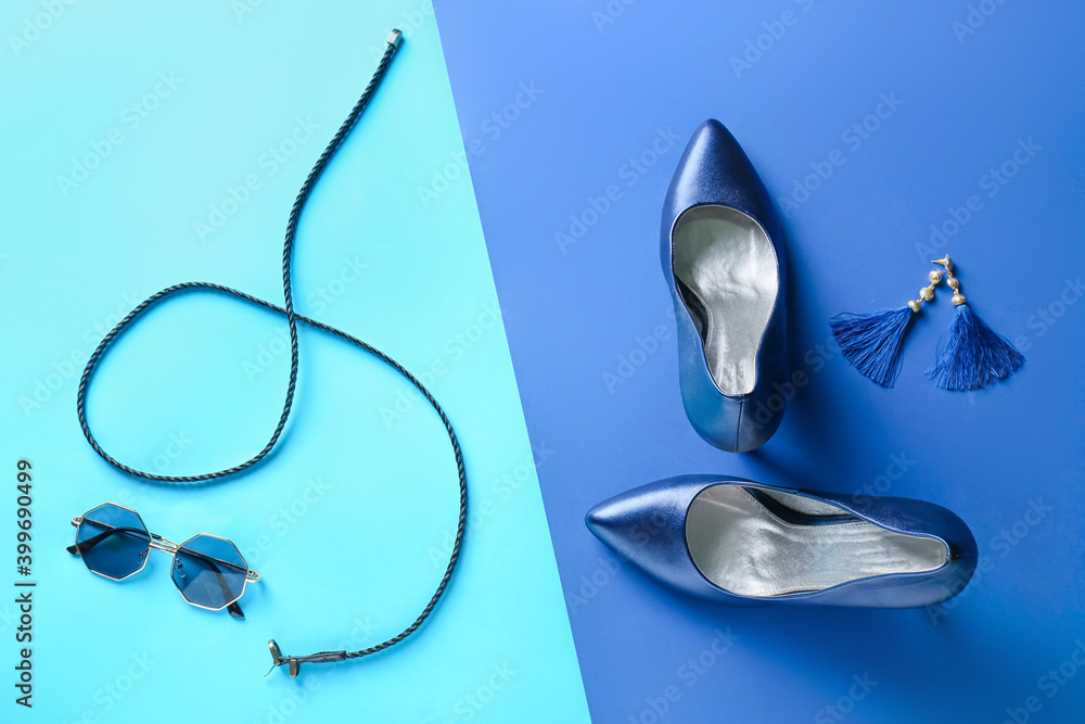 Female shoes and accessories on color background