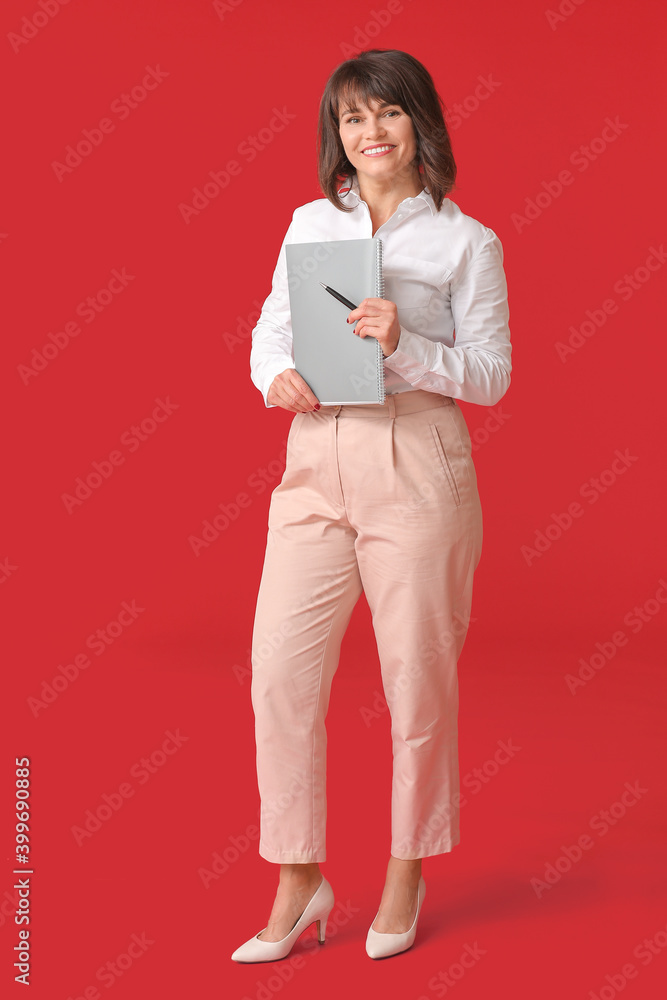 Beautiful mature businesswoman on color background