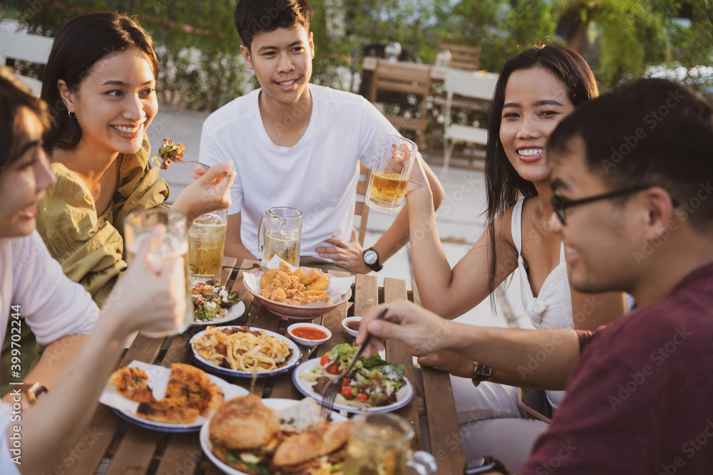 Group holiday party of asian people Eating dinner and drinking beer at home