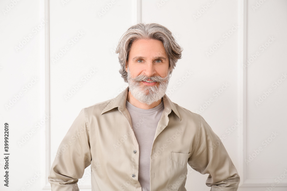 Mature man with grey hair on light background