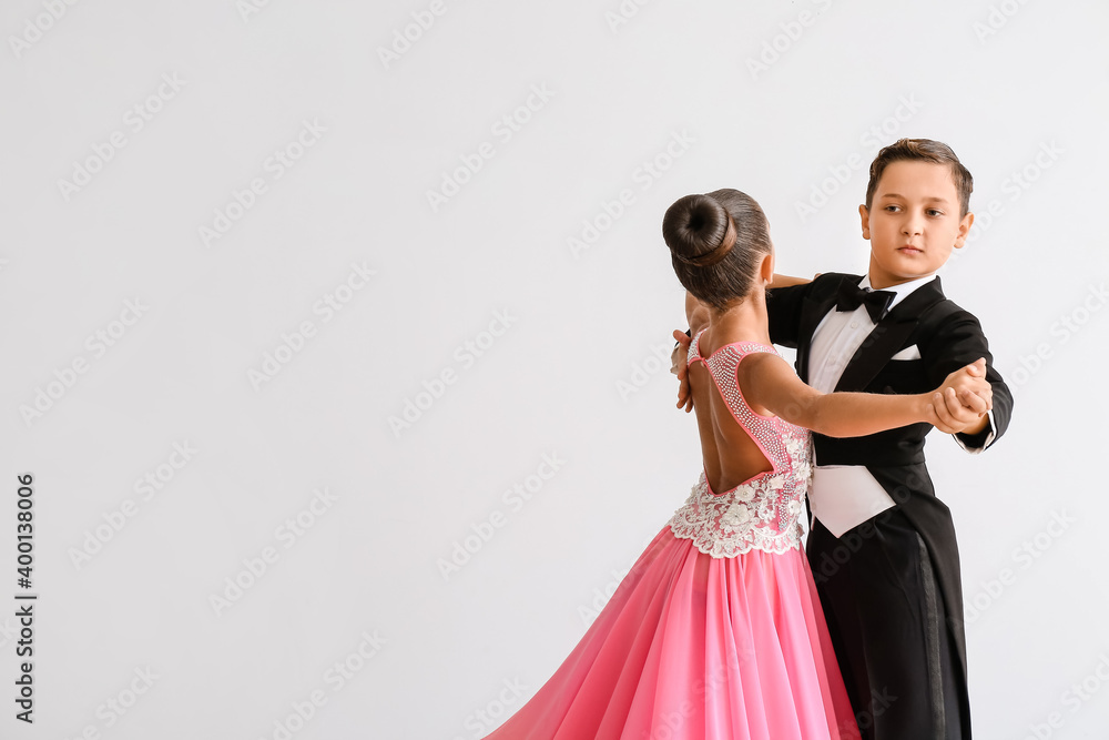 Cute little children dancing against light background