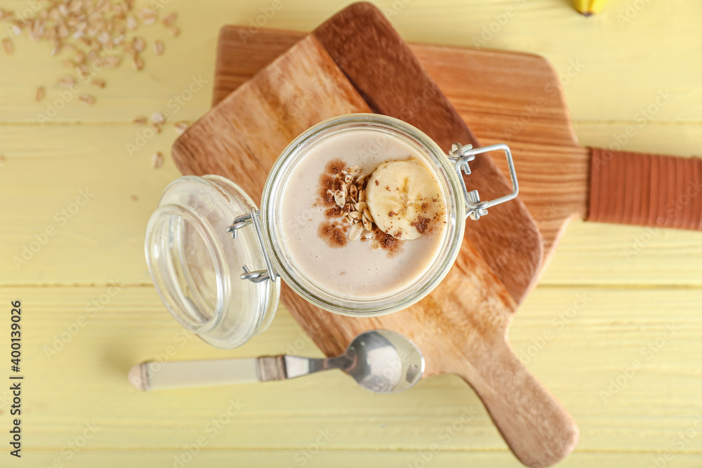 Jar of tasty banana smoothie on table