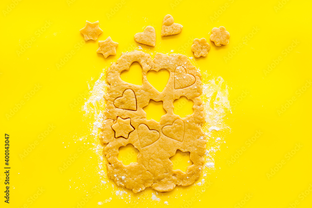 Cutting out heart-shaped cookies on dough top view