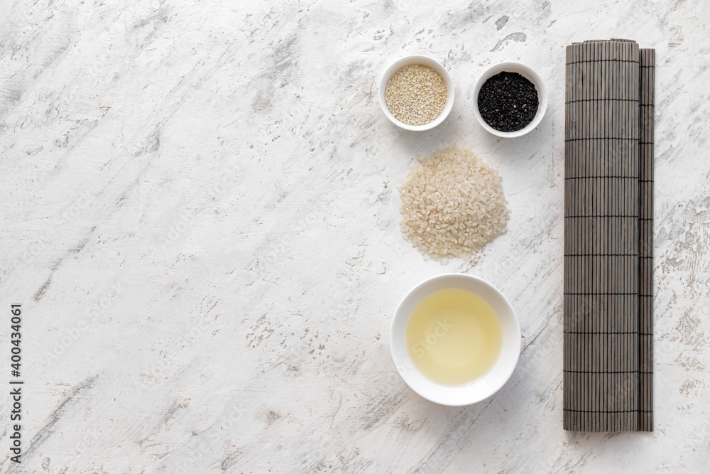 Composition with ingredients for preparing sushi rolls and rice vinegar on light background