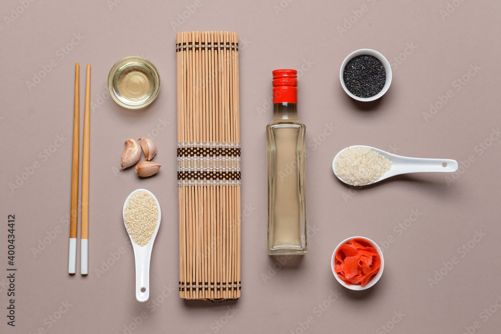 Composition with ingredients for preparing sushi rolls and rice vinegar on color background