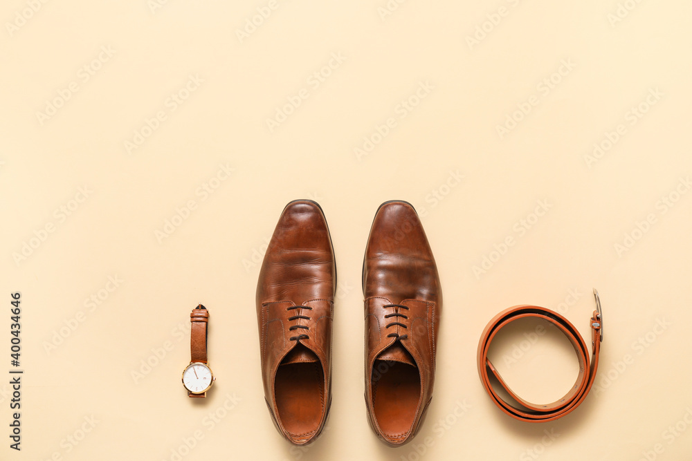 Stylish male accessories and classic leather shoes on color background