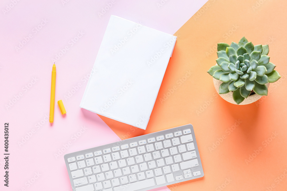 Composition with blank book and computer keyboard on color background