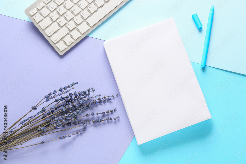 Composition with blank book and computer keyboard on color background