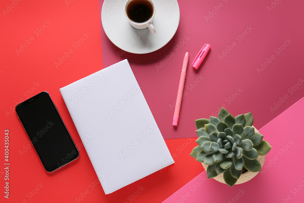 Composition with blank book and phone on color background