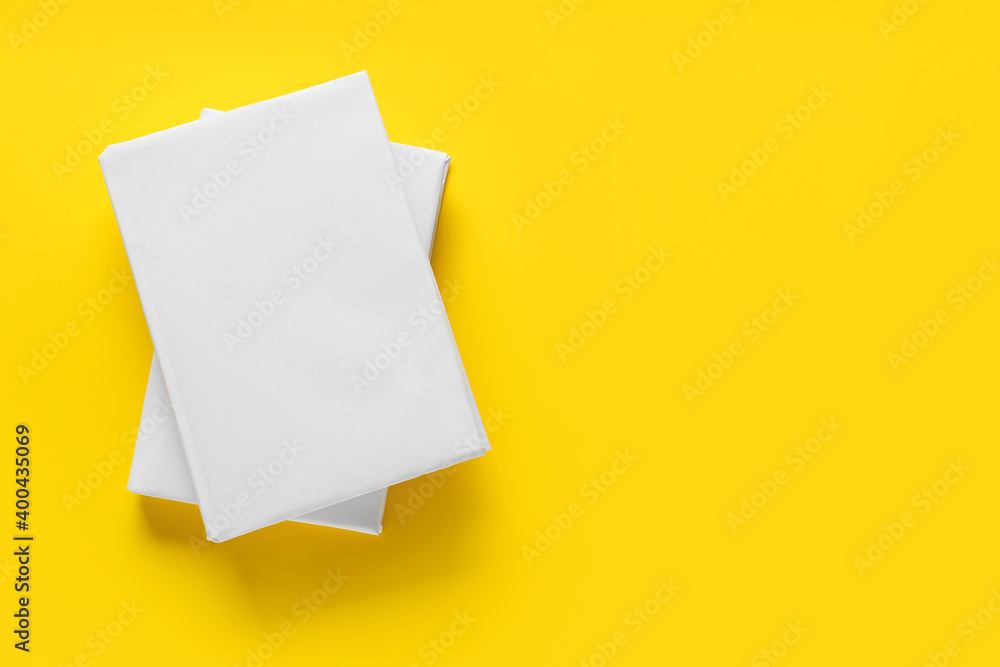 Blank books on color background