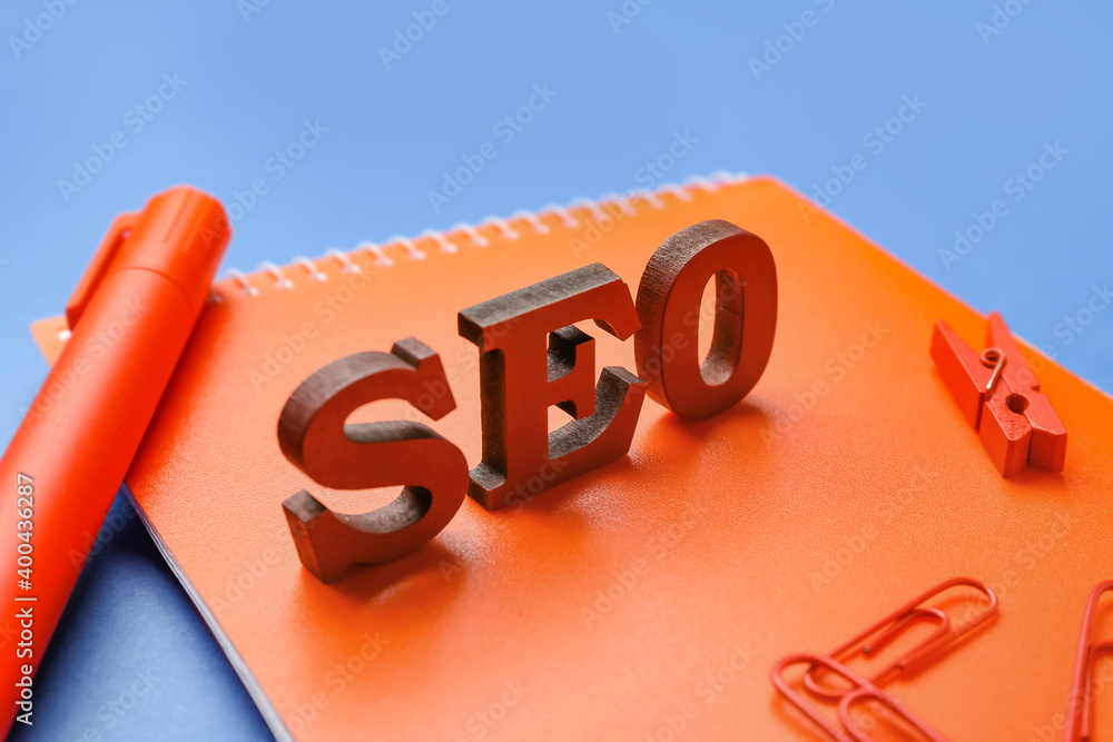 Abbreviation SEO with stationery on color background