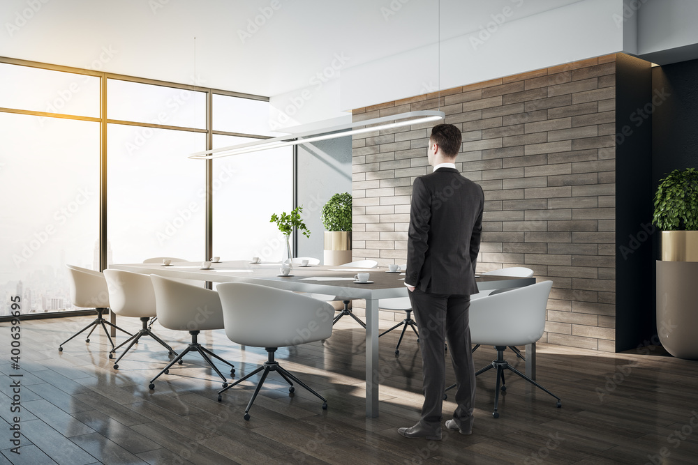 Side view of businessman standing in conference interior