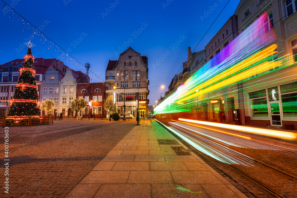 Christmas tram and decorations at the market square in Grudziądz at dusk. Poland