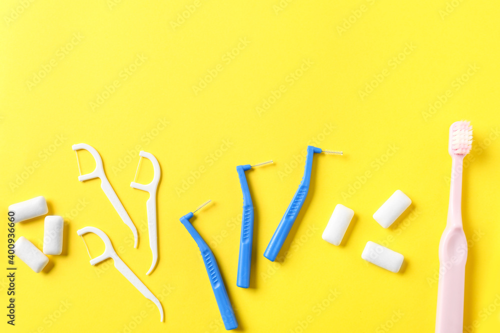 Toothbrushes for dental braces and floss on color background