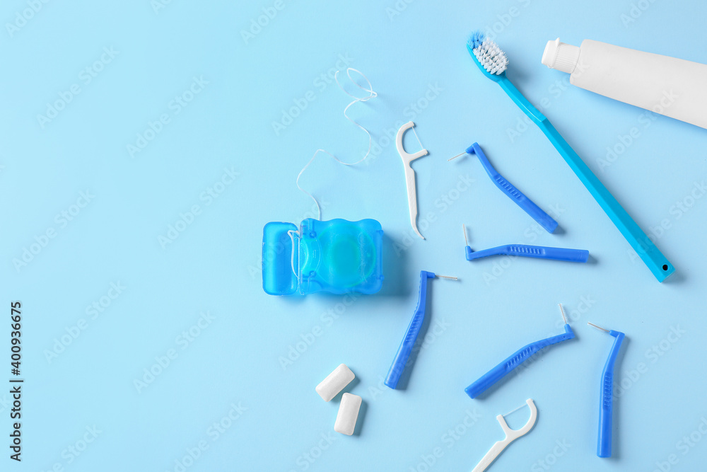 Toothbrushes for dental braces, floss and paste on color background