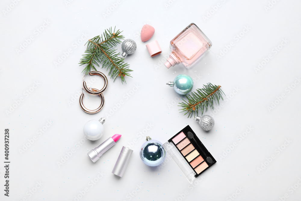 Frame made of cosmetics with Christmas decor on white background