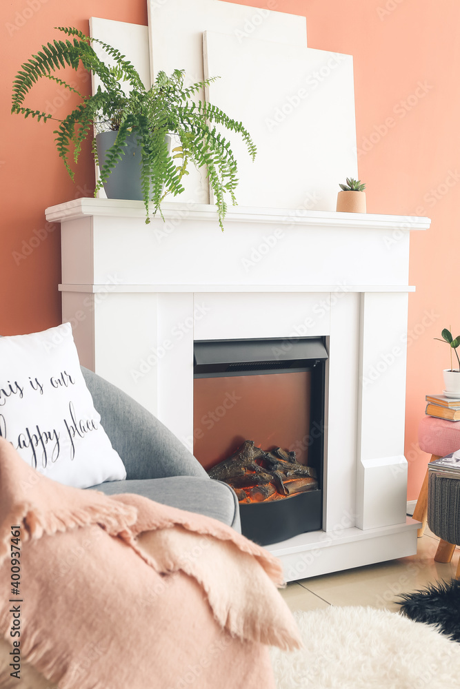 Fireplace with armchair in interior of room