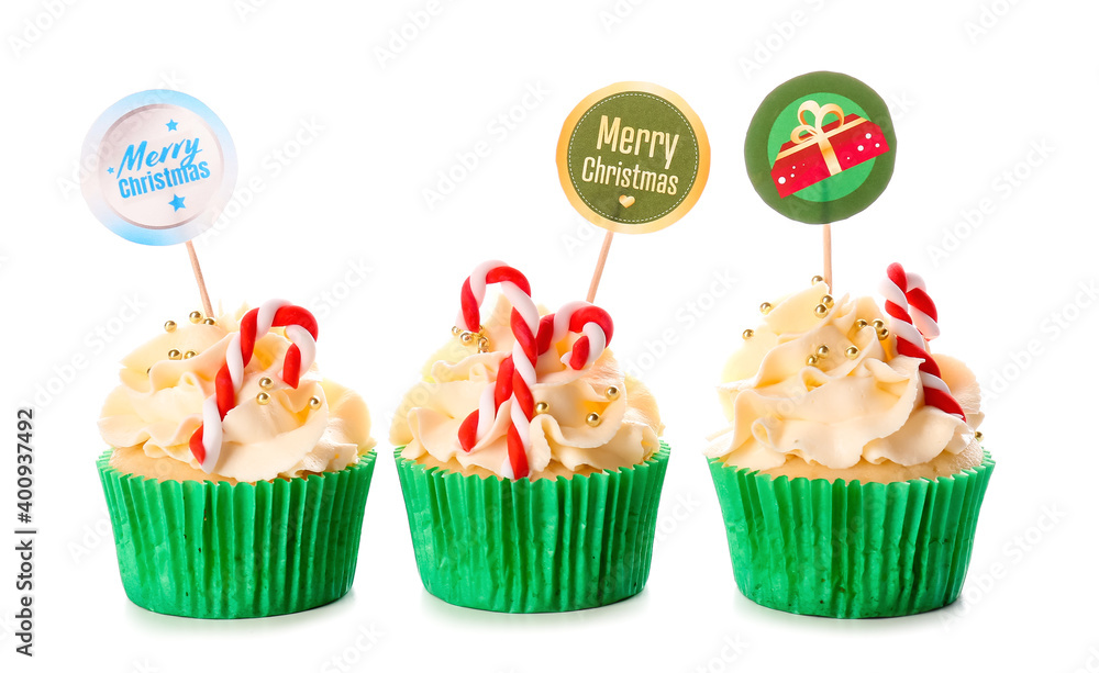 Tasty Christmas cupcakes on white background