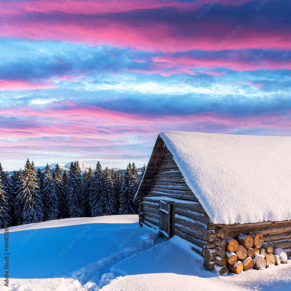 Fantastic winter landscape with wooden house in snowy mountains. Christmas holiday concept. Carpathi