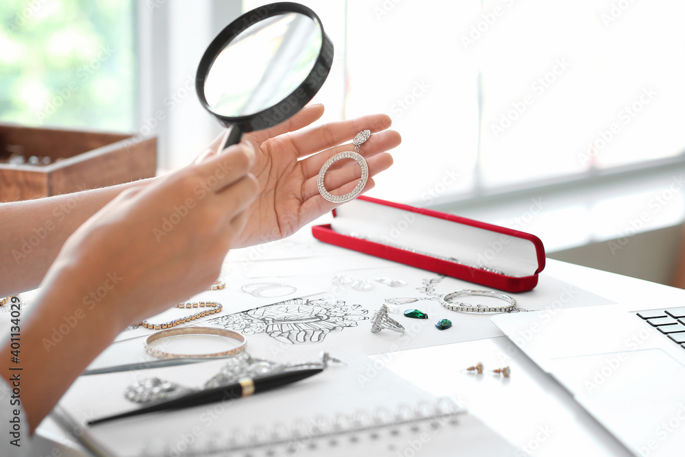 Female jewelry designer working in office, closeup