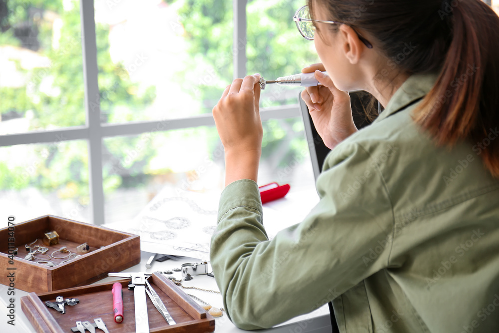 Female jewelry designer working in office