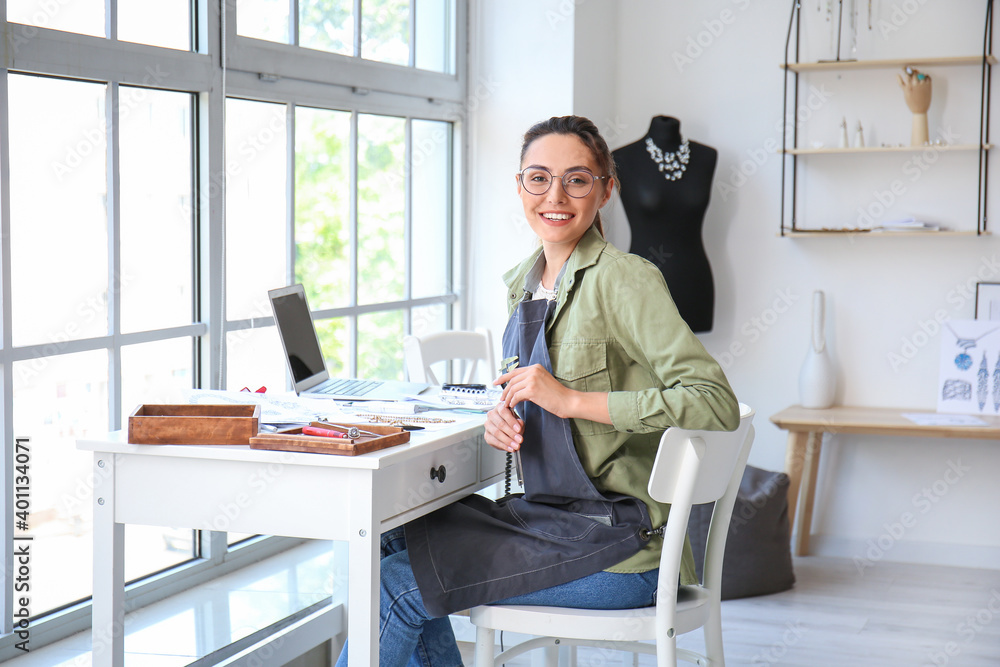 Female jewelry designer working in office