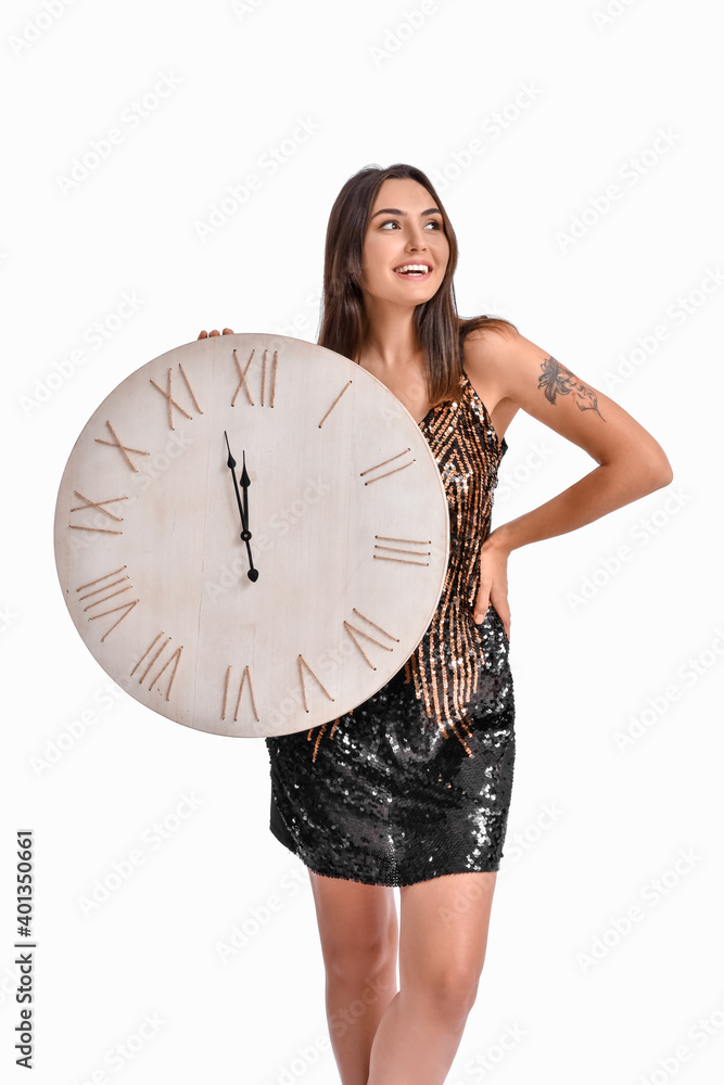 Beautiful young woman with clock on grey background