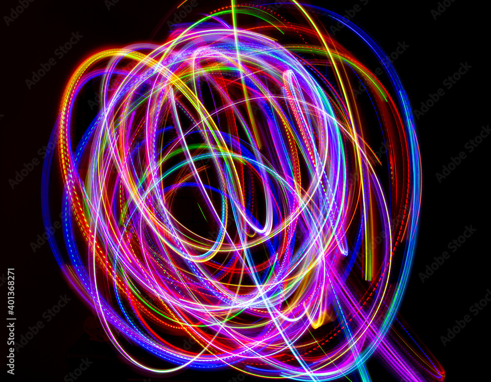 Abstract multicolored lines drawn by light on a black background