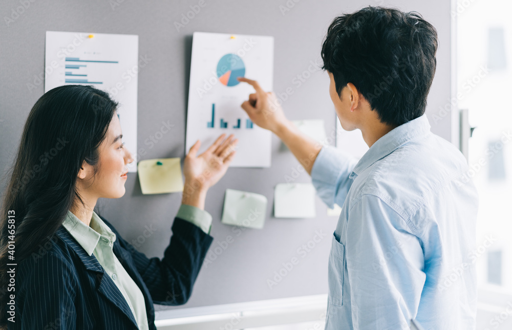 Two young business people are discussing upcoming plans