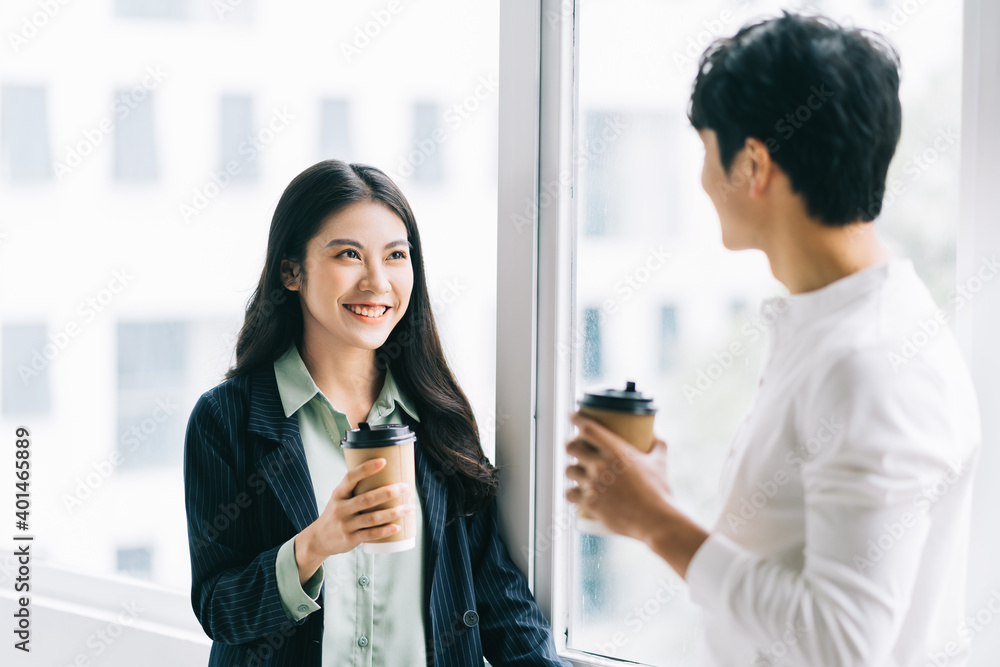 Businessman and businesswoman are discussing each other during lunch break