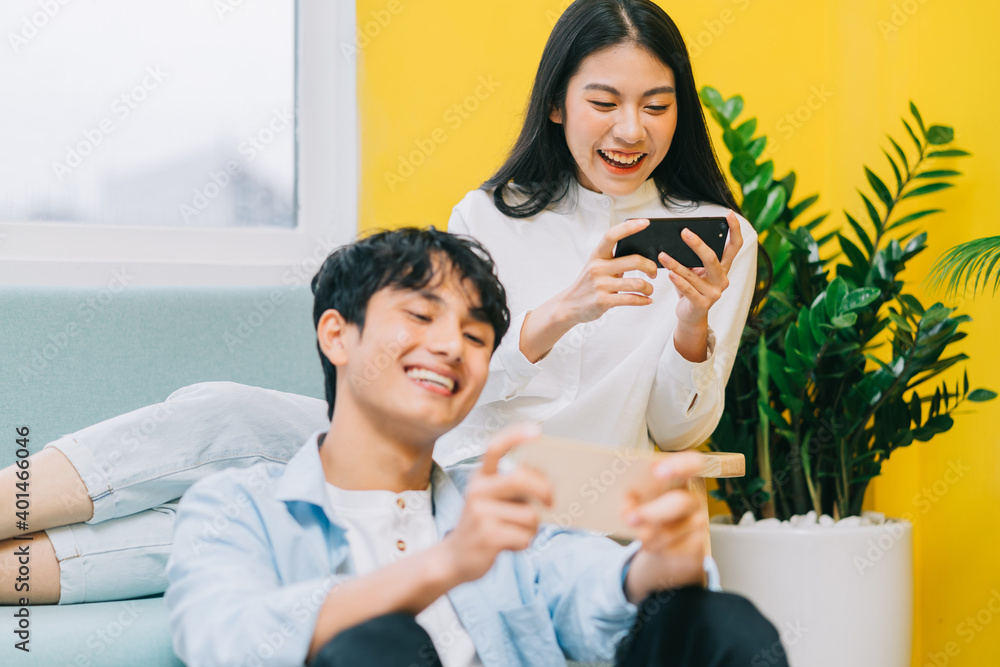 Asian couple playing games at home together, the happy life of a newlyweds