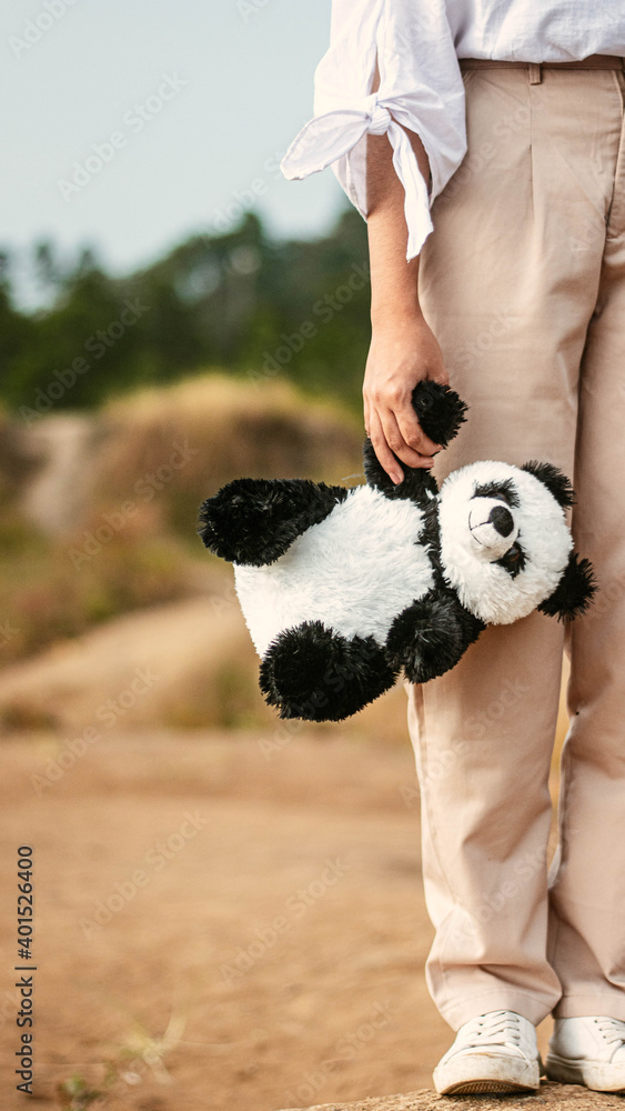 child playing with a panda doll