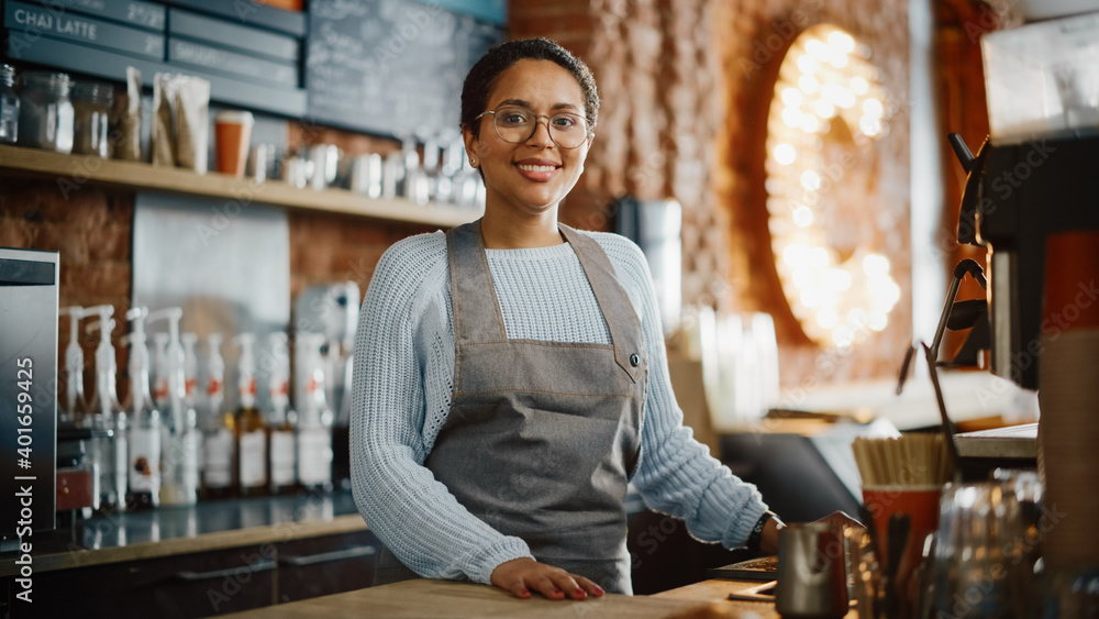 Beautiful Latin American Female Barista with Short Hair and Glasses is Projecting a Happy Smile in C