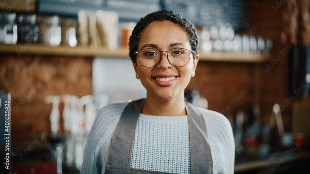 Beautiful Latin American Female Barista with Short Hair and Glasses is Projecting a Happy Smile in C