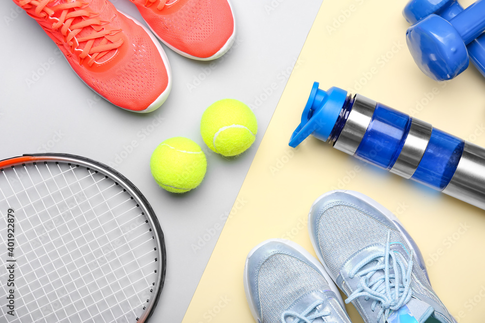 Sportive shoes and tennis balls on color background