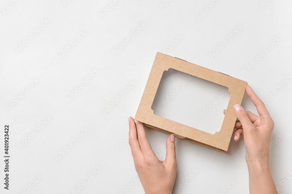 Hands with cardboard box on white background