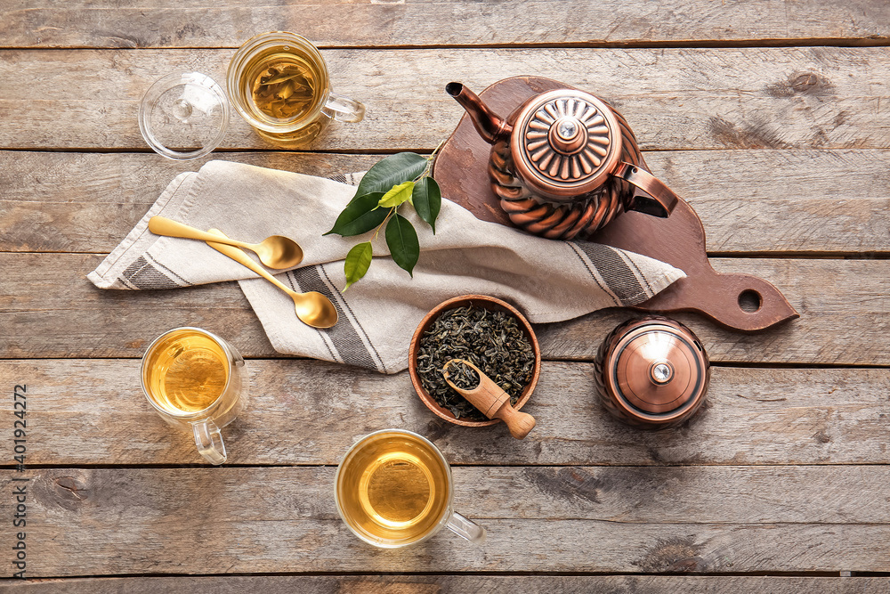 Composition with cups of green tea on wooden table