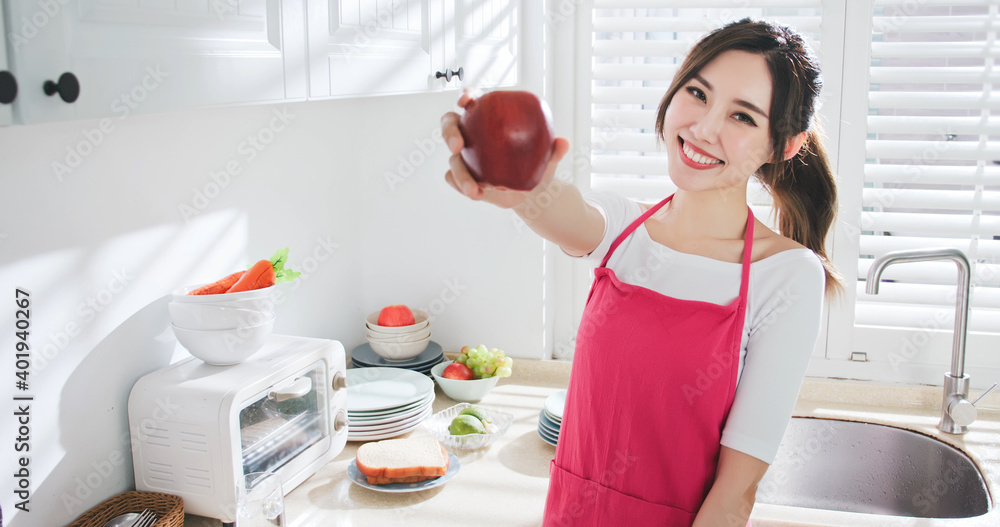 Asian housewife hold an apple