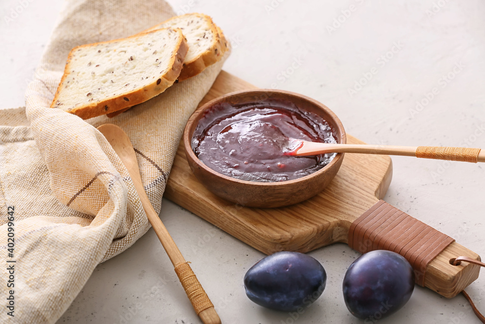 Bowl with delicious homemade plum jam on table