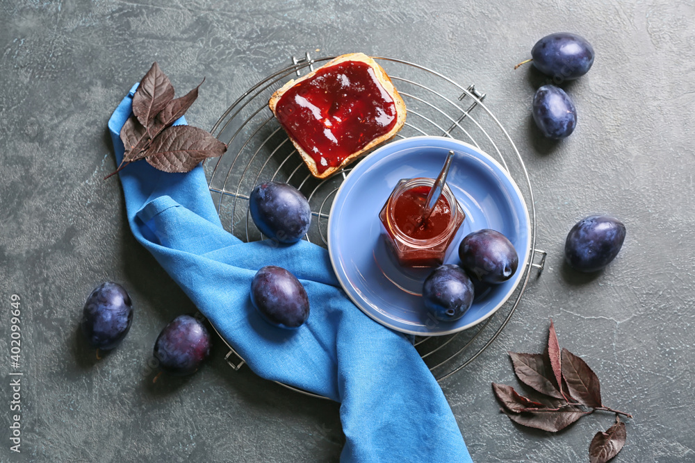 Composition with delicious homemade plum jam on table