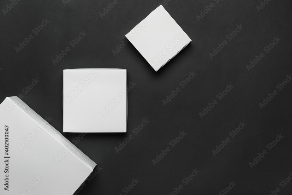 Blank cardboard boxes on dark background